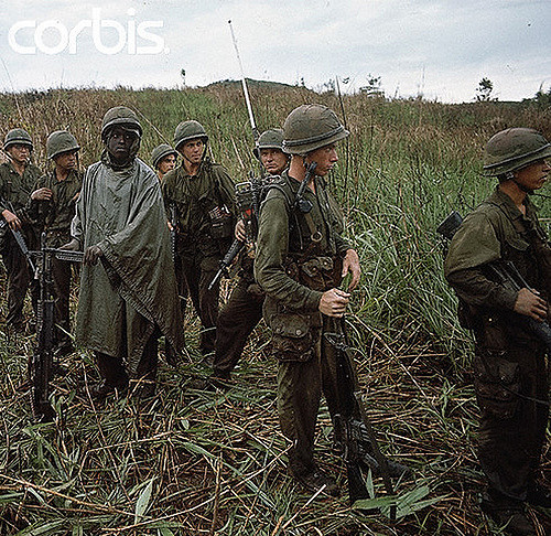 29 Apr 1967, Hill 861, South Vietnam --- 4/29/1967-Hill 861, South Vietnam- Picture shows US Marines standing on Hill 861 after a three day battle with the North Vietnamese. They are all carrying heavy artillery and the man in the foreground is leaning on his gun and wearing a pancho. --- Image by © Bettmann/CORBIS